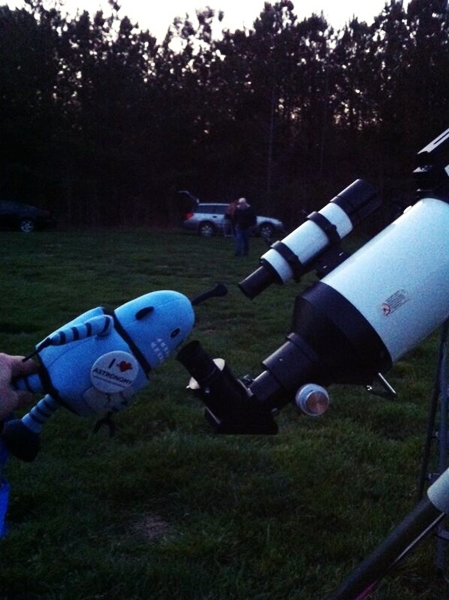 Kelvin peers through a telescope at Little River Regional Park