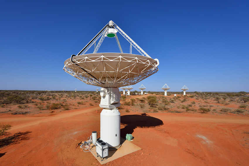 Image 1:  Some of  the ASKAP antennas. A Mark I PAF is visible in green atop the nearest antenna. Credit: Dragonfly Media